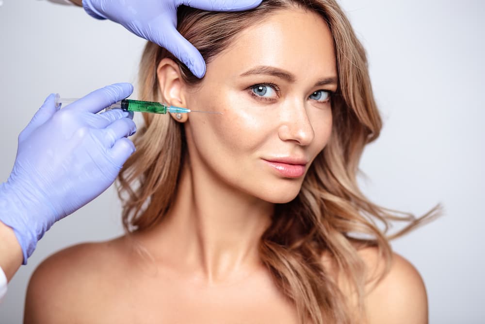 Botox being injected into the skin to enhance beauty