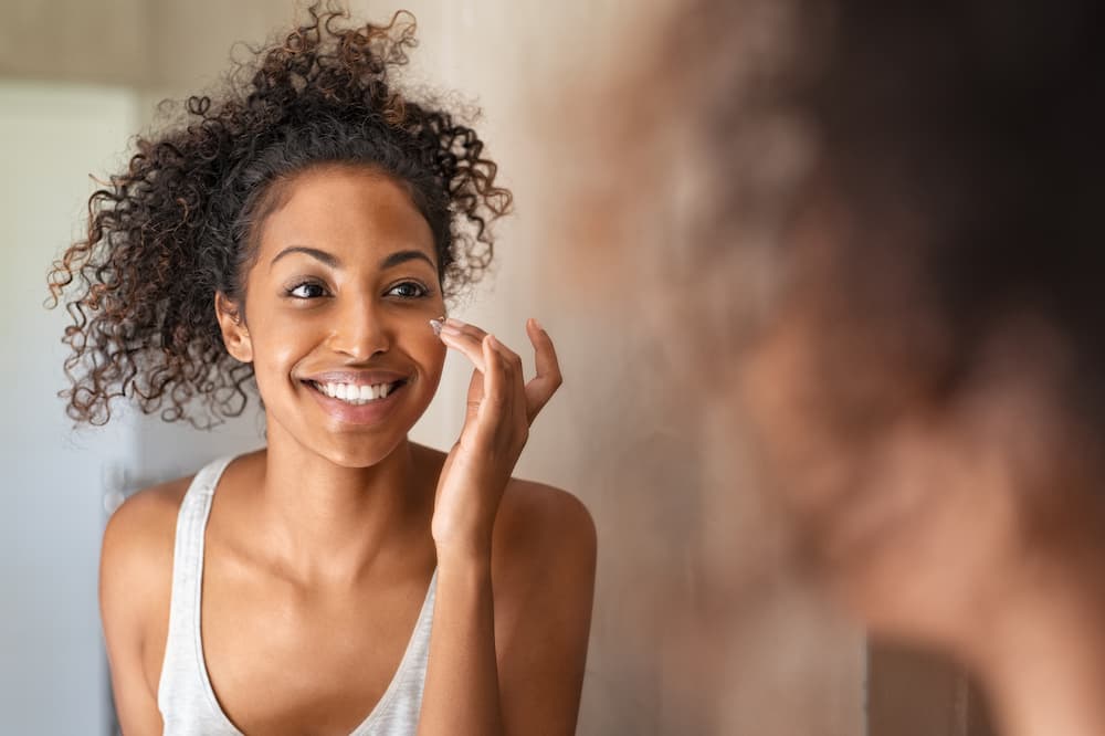 A women using skin care products to enhance her beauty